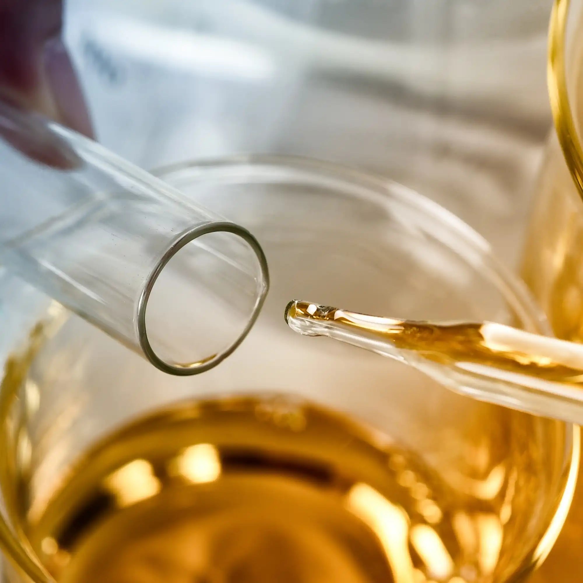 Golden fragrance oil in a pipette