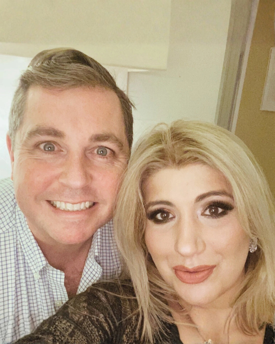 Lillie and Christopher Edgar, the founders of Told London, smiling together in a selfie.