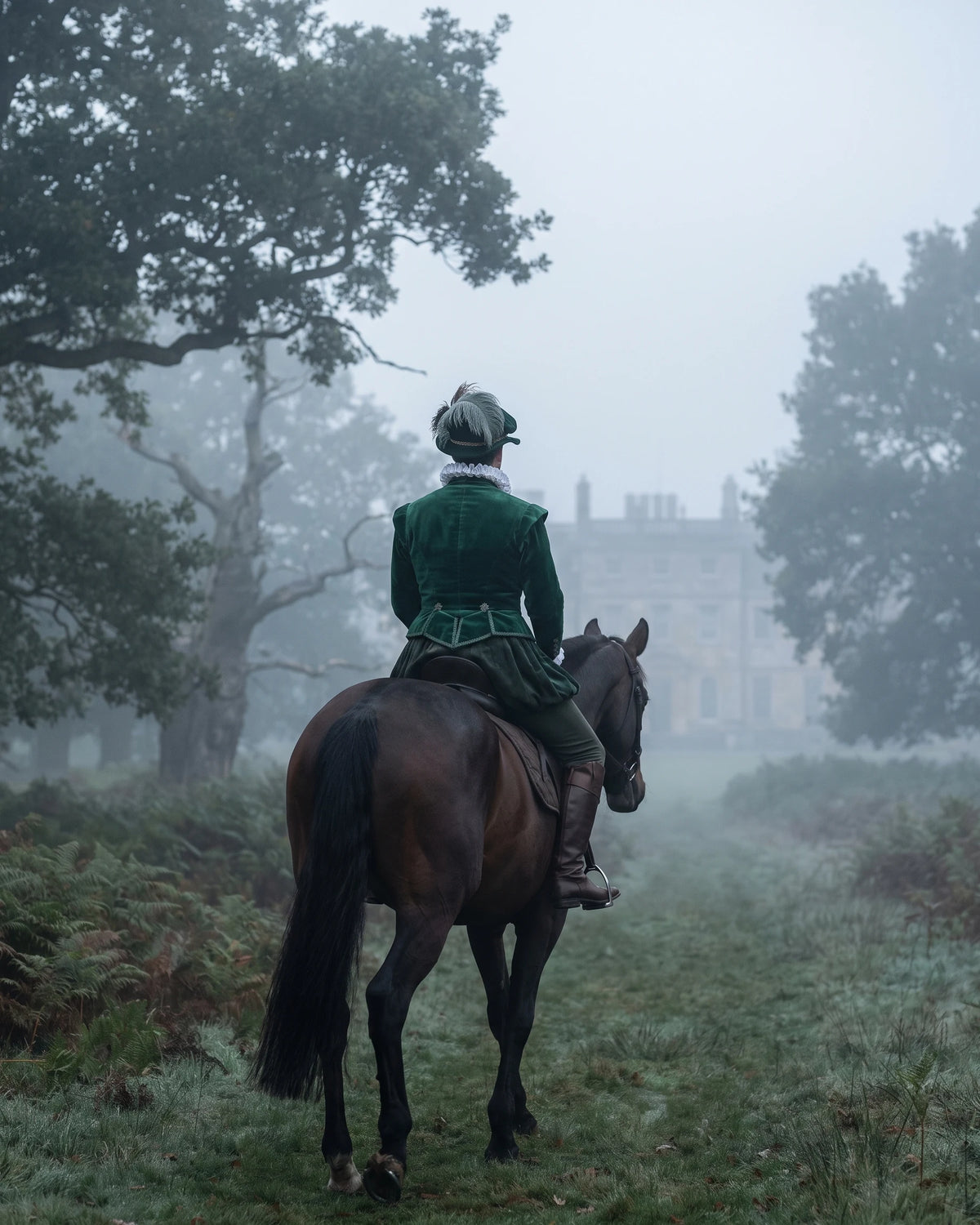A rider in a green coat on a dark horse, seen from behind on a path through misty parkland.